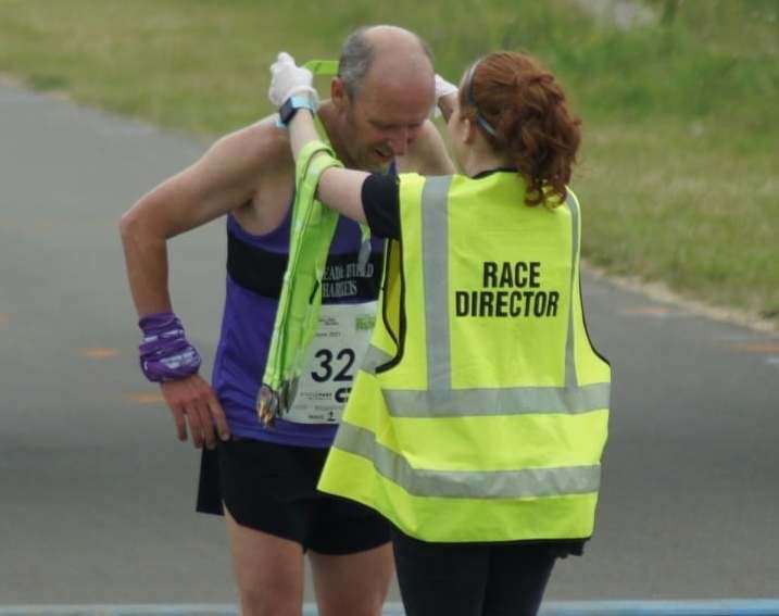 North Downs Run race director Colette Smith gives a medal to Mark Champion from Istead and Ifield Harriers. (48758970)