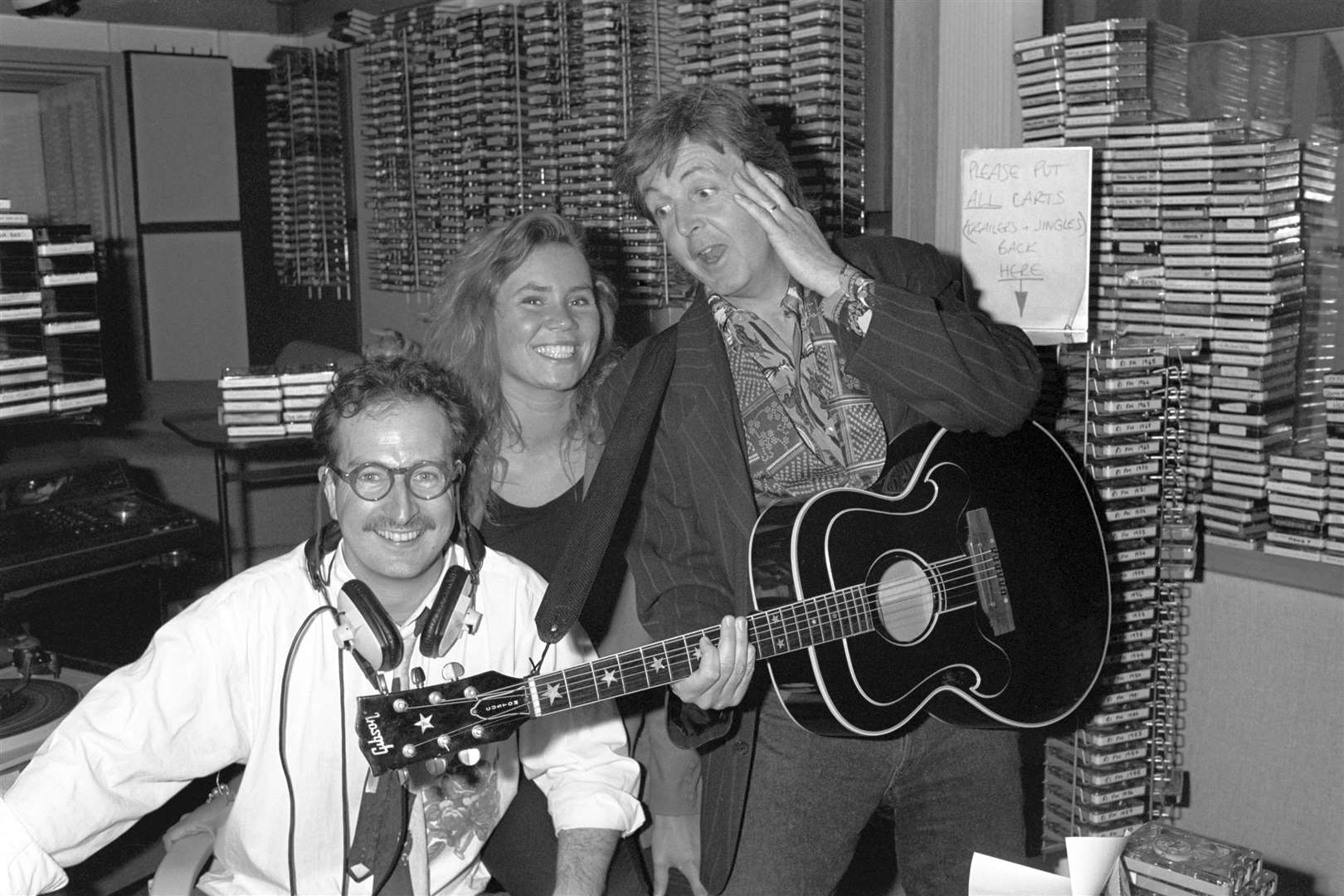 Sir Paul McCartney surprising Radio 1 DJ Steve Wright and his production assistant Dianne Oxberry (PA)
