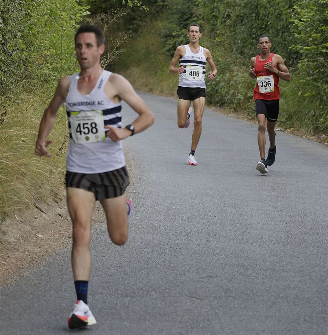 Third place Jay Smith of Tonbridge AC (No.458) keeps a gap behind. Picture: Barry Goodwin
