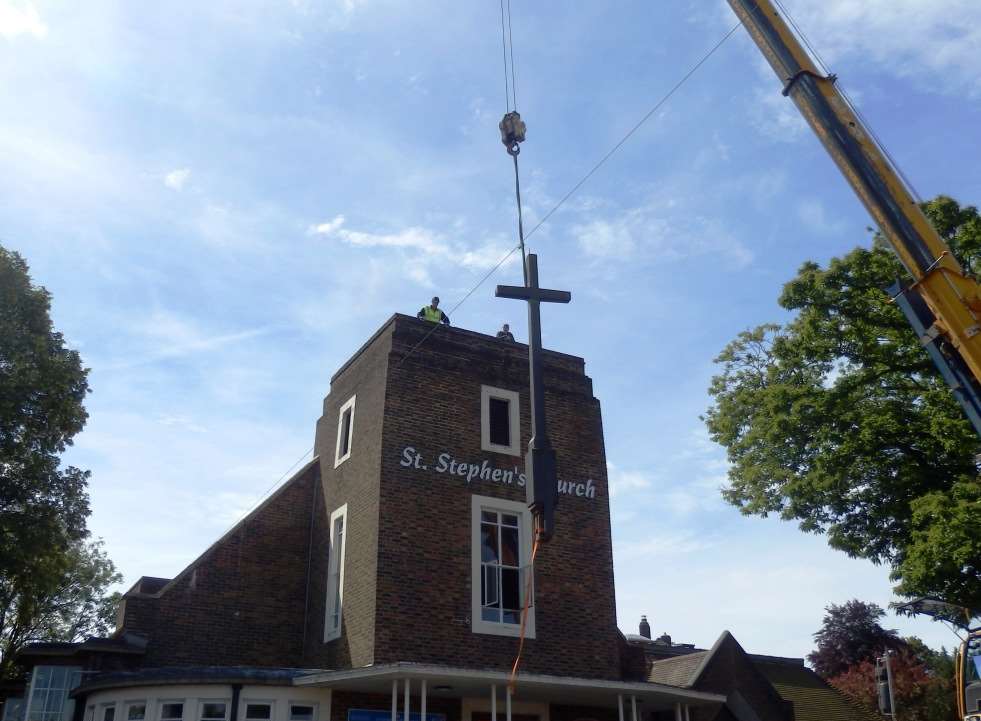 The church cross being removed.