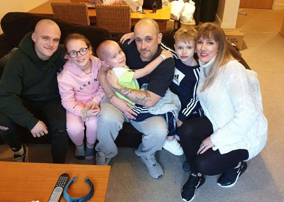George Dodgson, four, cuddles his family
