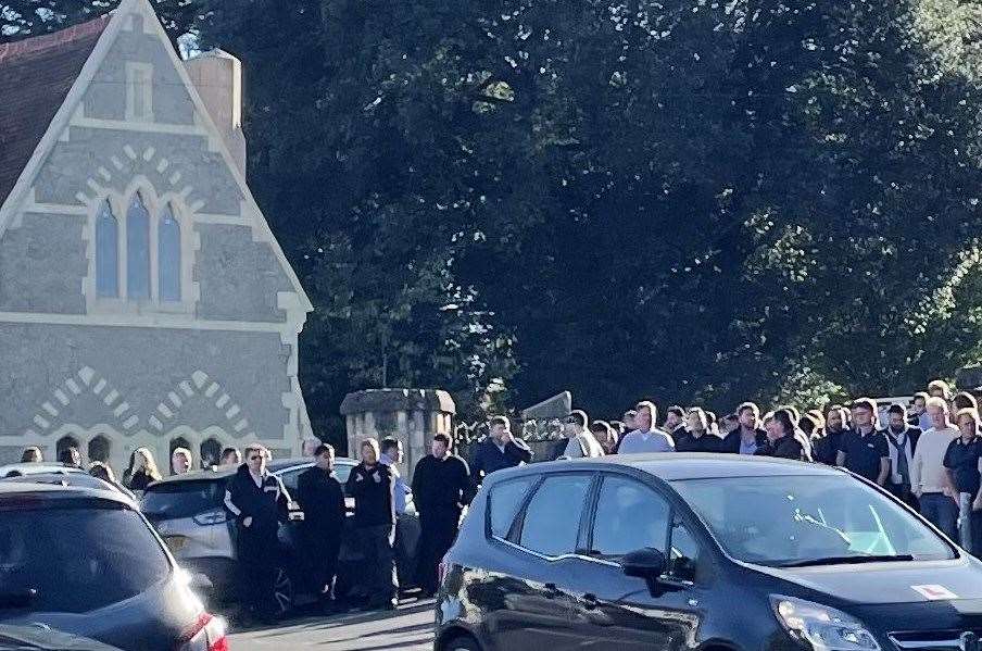 Many mourners have followed the procession to the cemetery