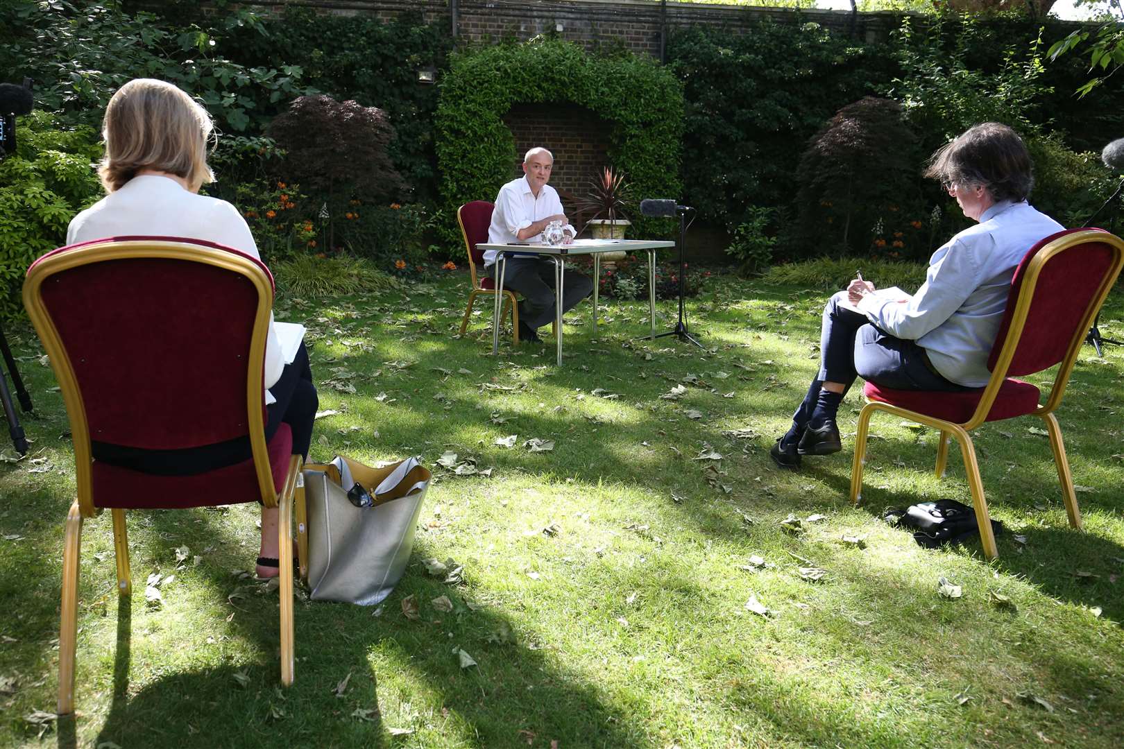 Journalists sit at a distance while listening to Dominic Cummings, senior aide to Prime Minister Boris Johnson, who made a statement in the Downing Street rose garden about his trip to Durham during lockdown restrictions (Jonathan Brady/PA)