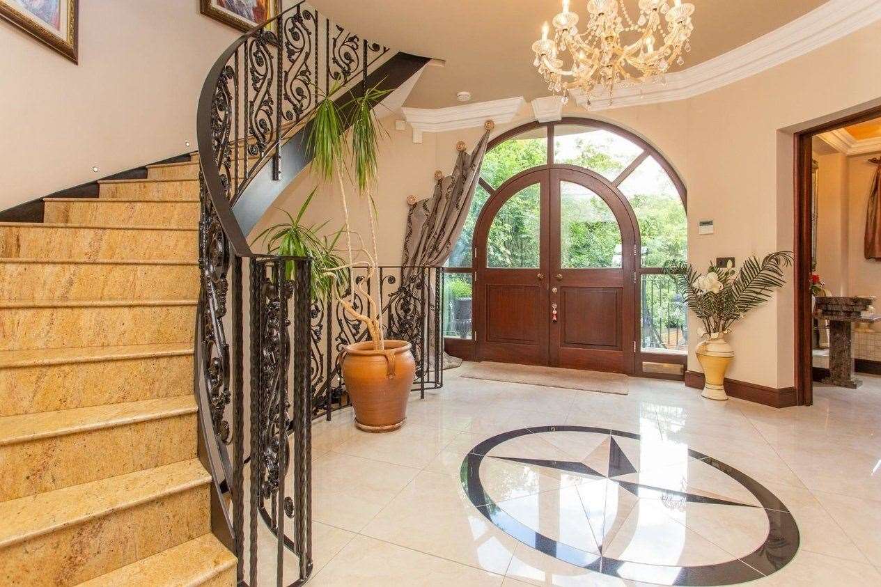 The sweeping staircase is not something you see in most homes. Picture: Miles and Barr