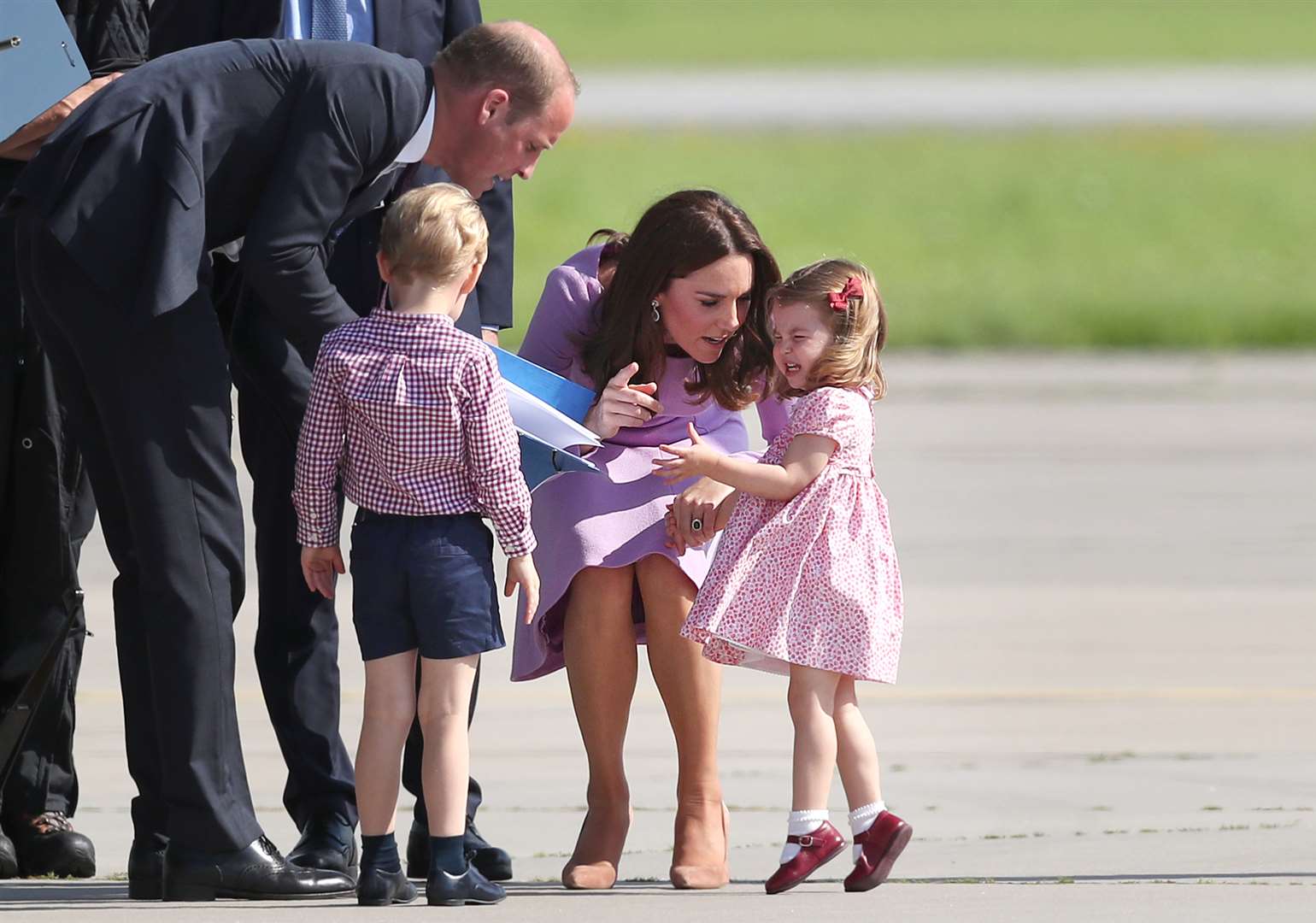 The Cambridges, George and two-year-old Charlotte, who was having a tantrum, at Hamburg Airport during the family’s three day tour of Germany (Jane Barlow/PA)