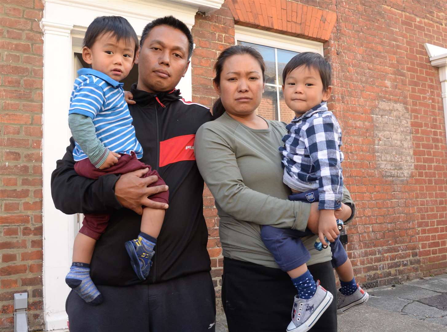 Robin, Mirinwon and their sons Joseph and Robin outside their home in Lansdown Road.