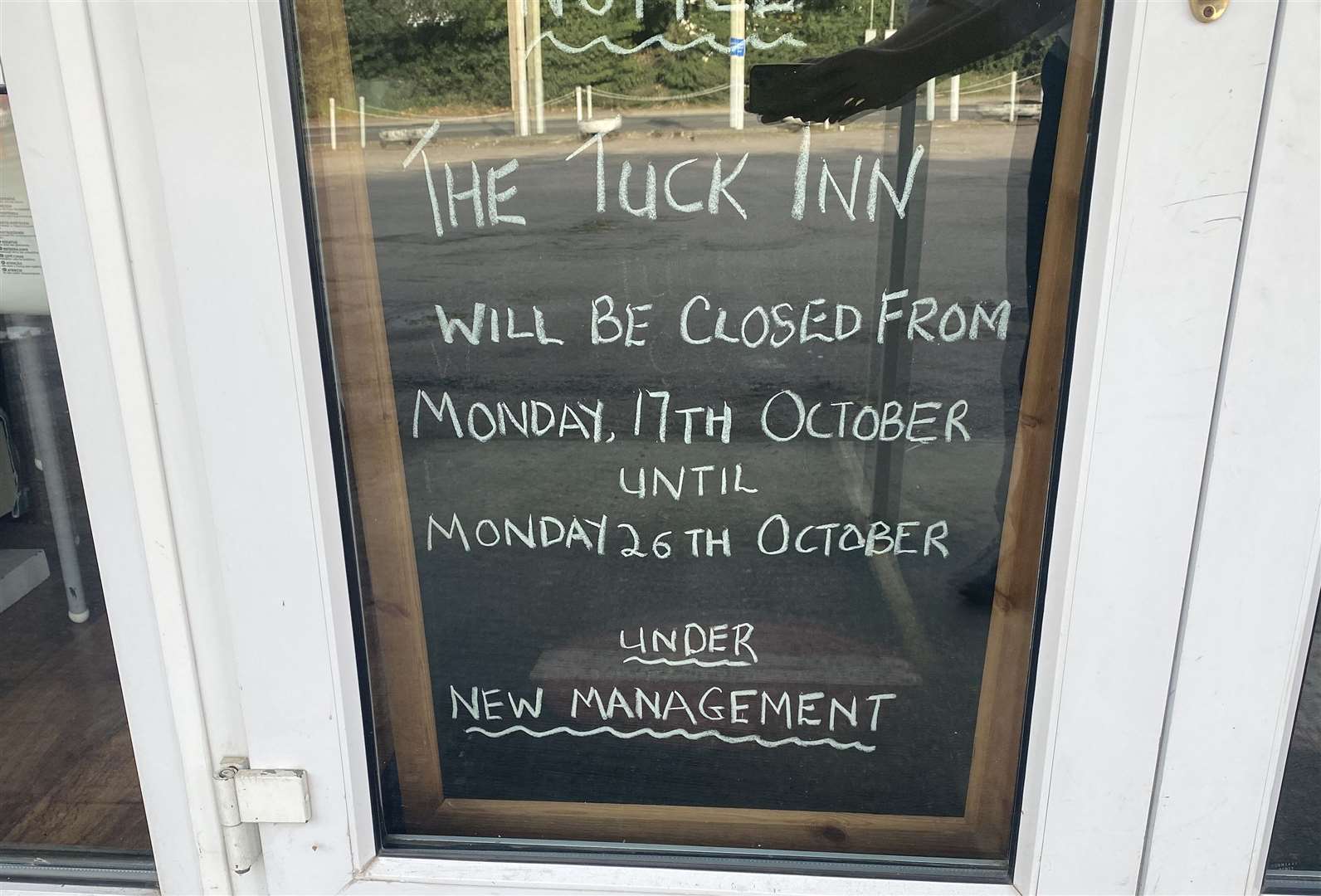A sign in the window explaining the Tuck Inn's closure