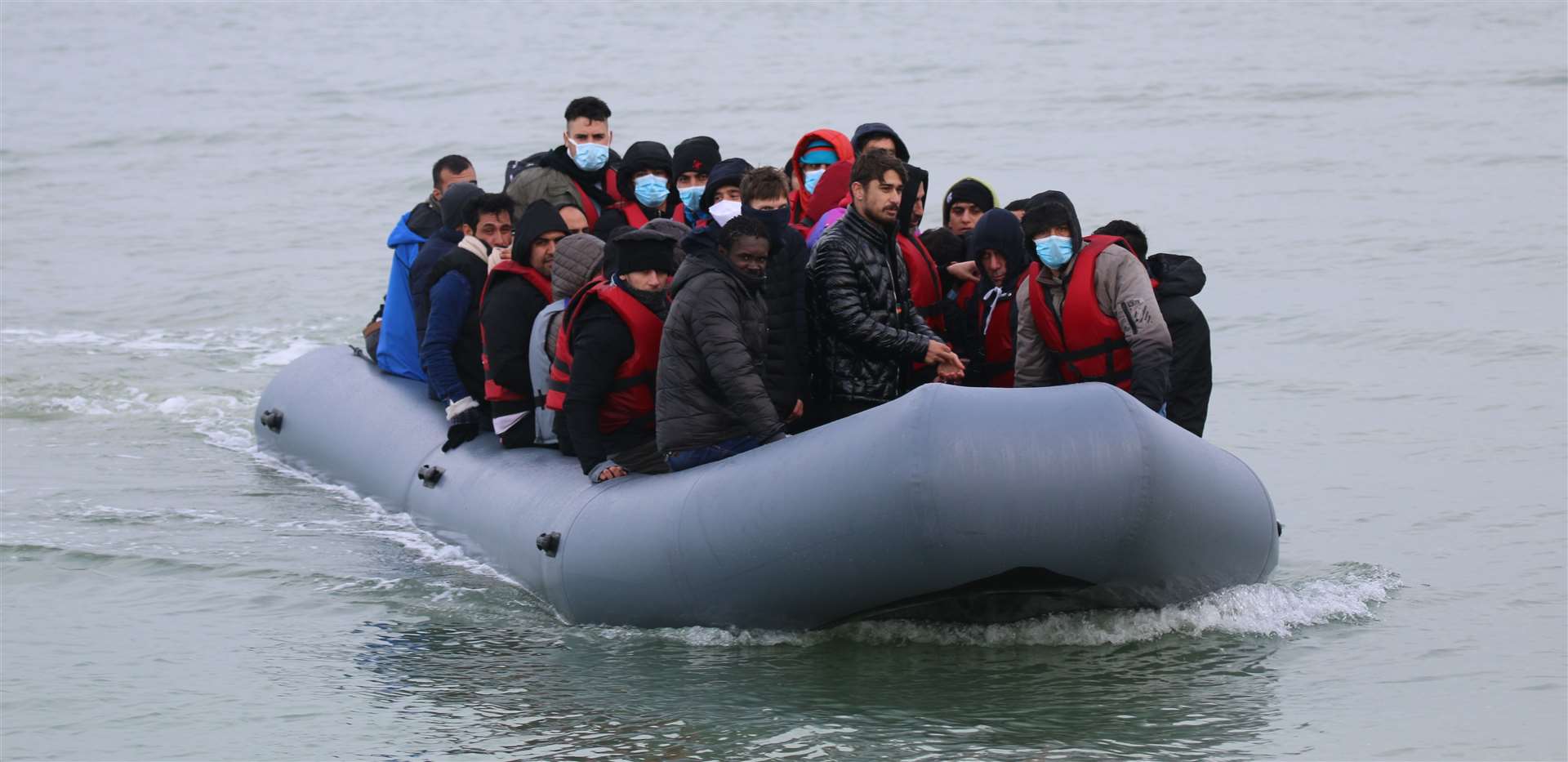 Asylum seekers landing on the beach in Kent