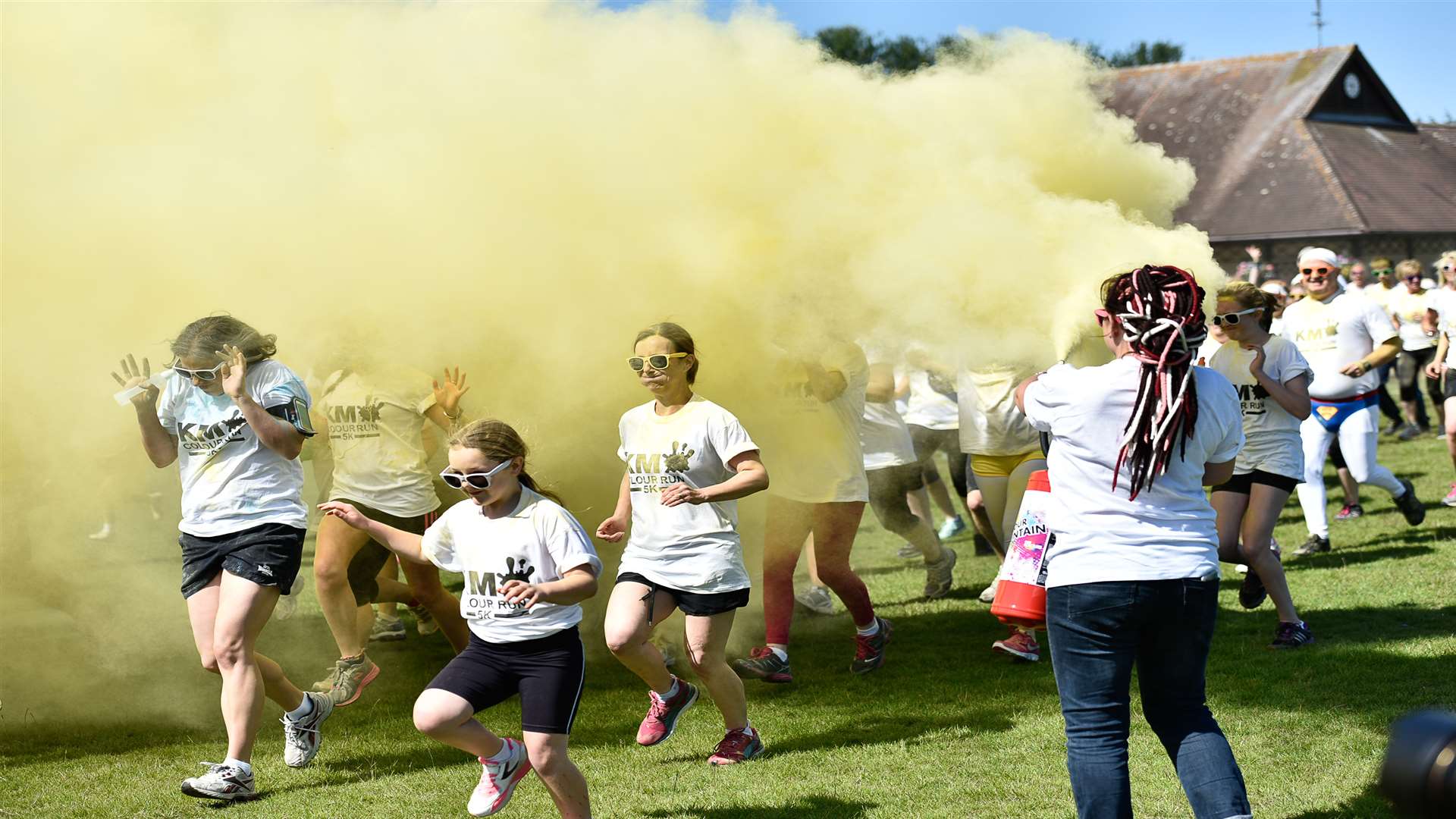 KM Colour Run participants make their way through a cloud of yellow powder.