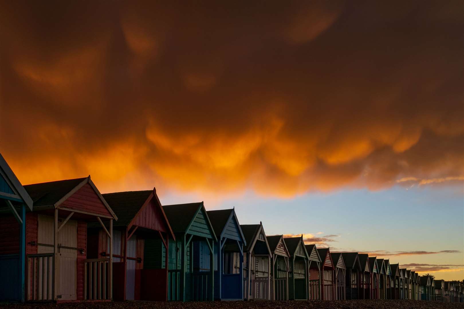 James McBean's winning photo of thunder clouds gathered over beach huts in Herne Bay
