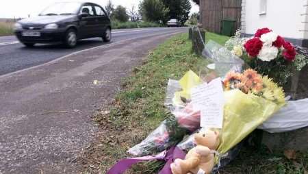 Flowers and a teddy bear at the scene of the crash. Picture: RICHARD EATON