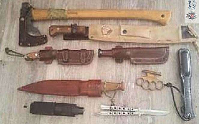 Knives, a knuckle duster and an axe were all seized during the raid. Picture: Kent Police