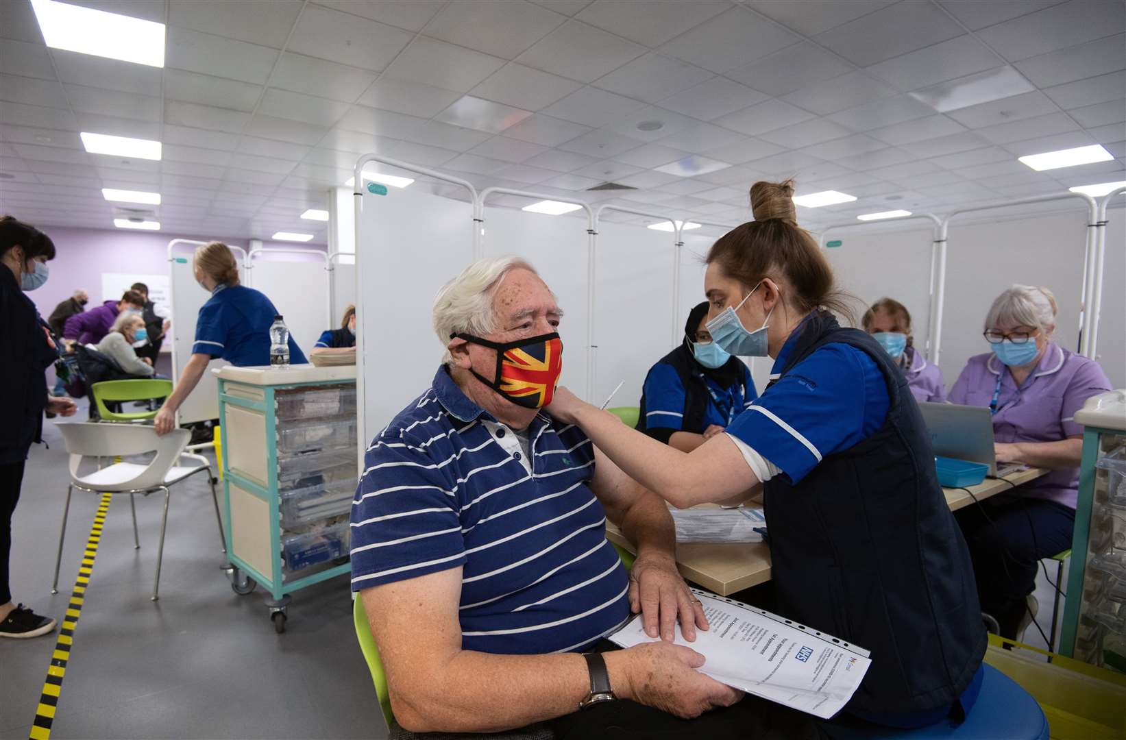 Robert Williams, 84, receives an injection of a Covid-19 vaccine at the NHS vaccine centre that has been set up at Robertson House in Stevenage, Hertfordshire (Joe Giddens/PA)