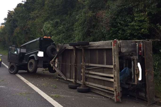 The car and overturned trailer. Picture: Highways England