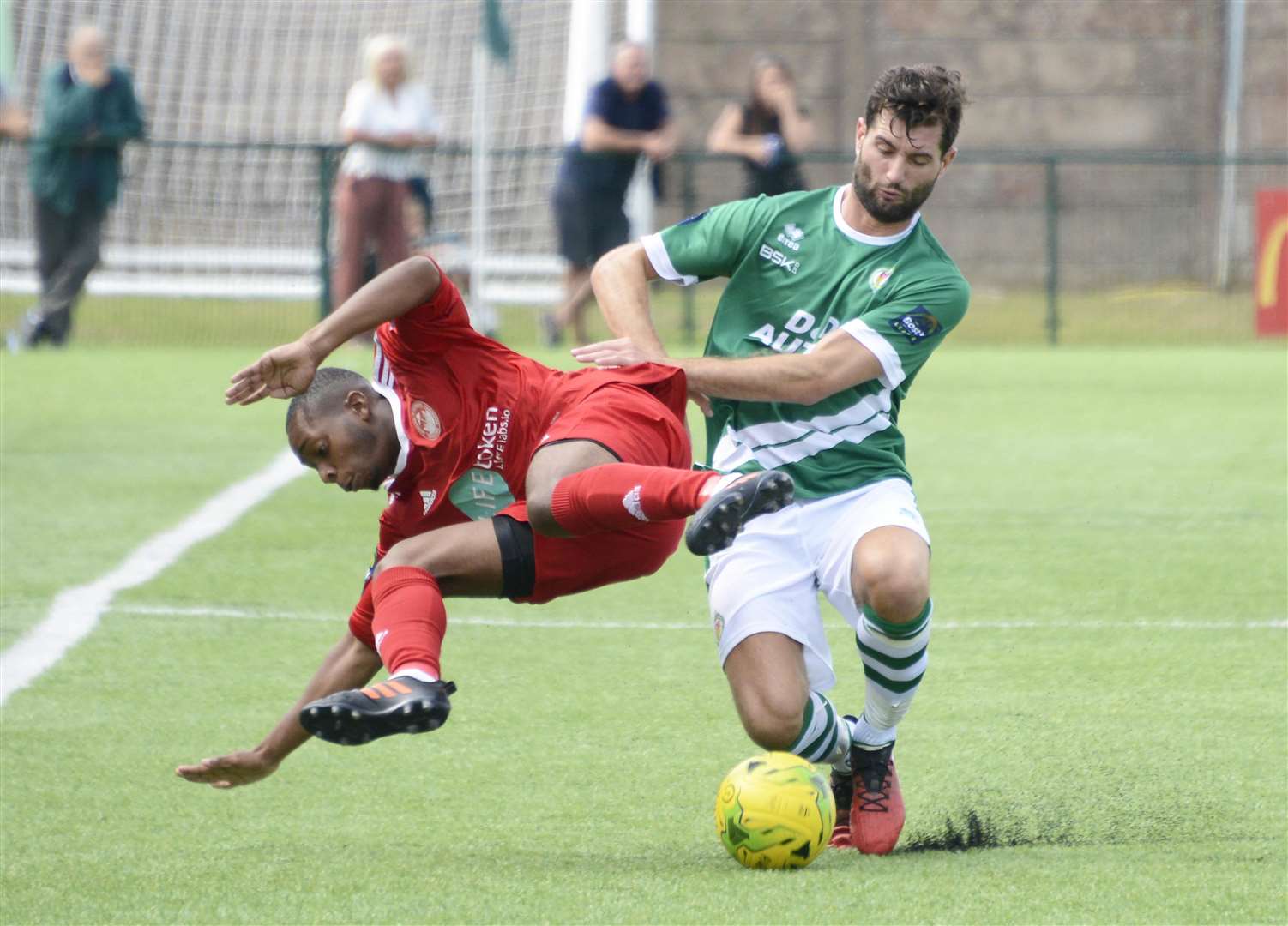 Hythe's Kieron Campbell is upended during the 3-1 defeat at Ashford Picture: Paul Amos