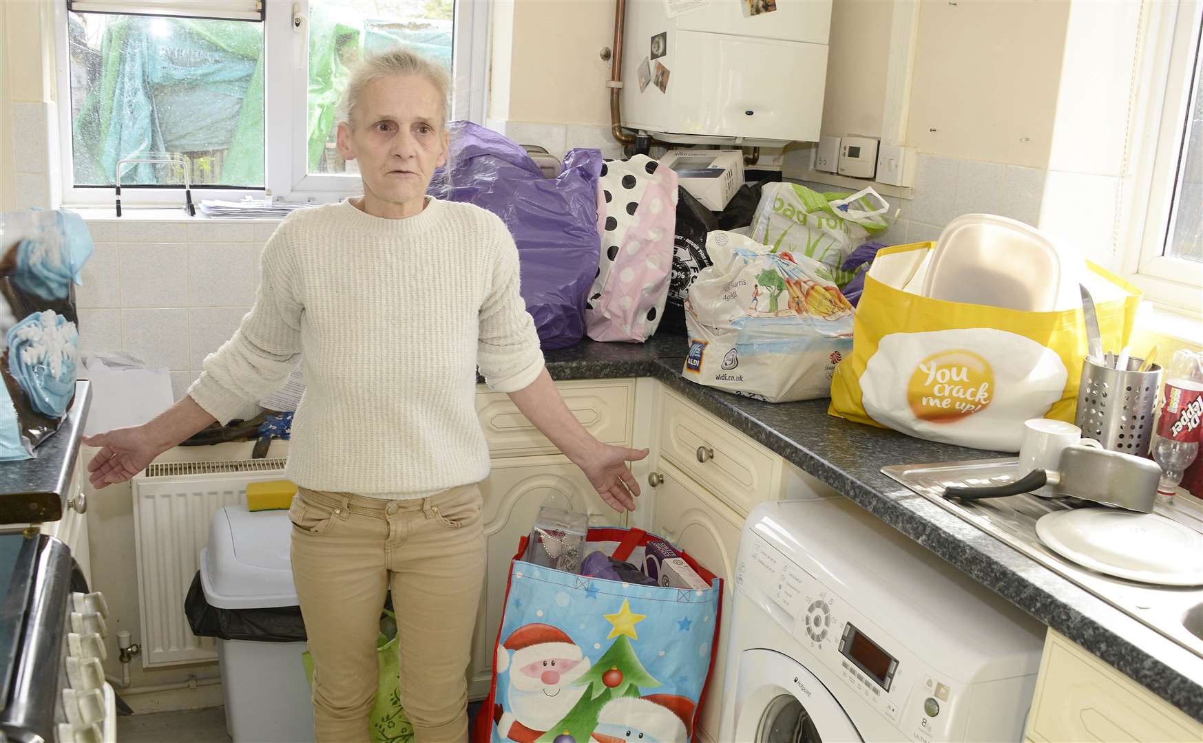 Jackie's kitchen doubles as a storage area because of damp elsewhere