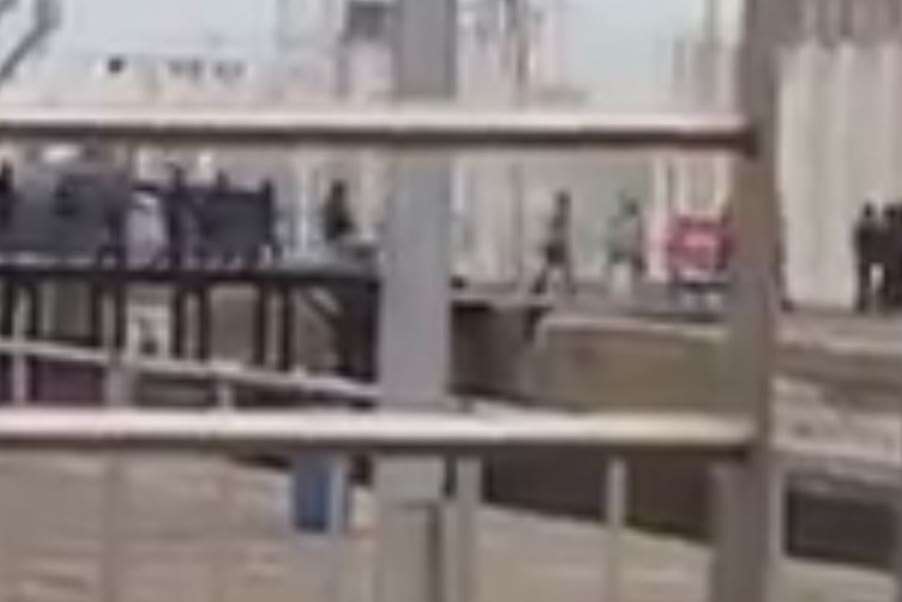 Migrants breach Calais dock fences and run into the port