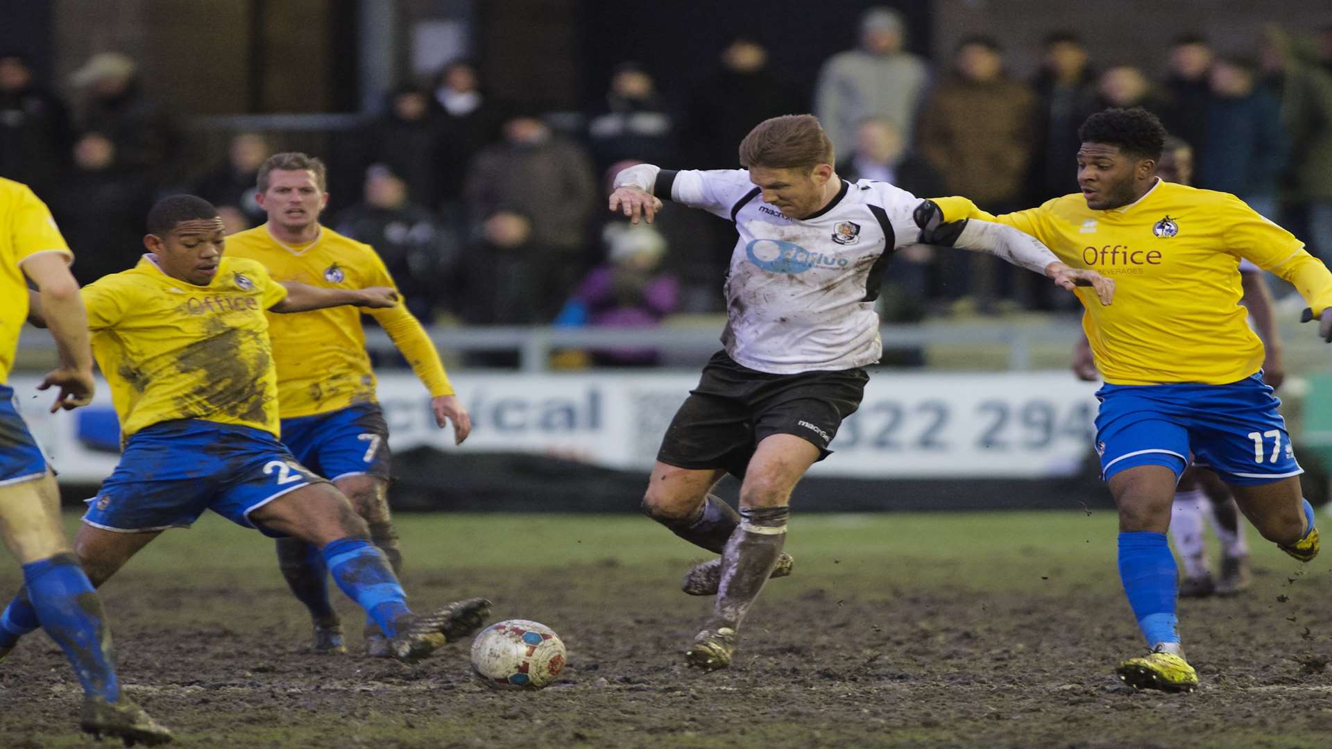 Elliot Bradbrook ploughs through the mud against Bristol Rovers last season Picture: Andy Payton