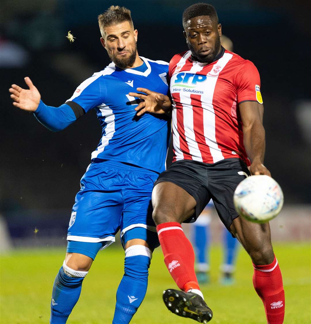 Max Ehmer and John Akinde do battle during Gillingham's game against Lincoln earlier this season Picture: Ady Kerry