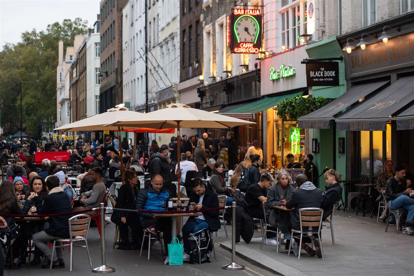 London’s Soho has banned cars so its bustling restaurant scene can host diners in the street (Dominic Lipinski/PA)