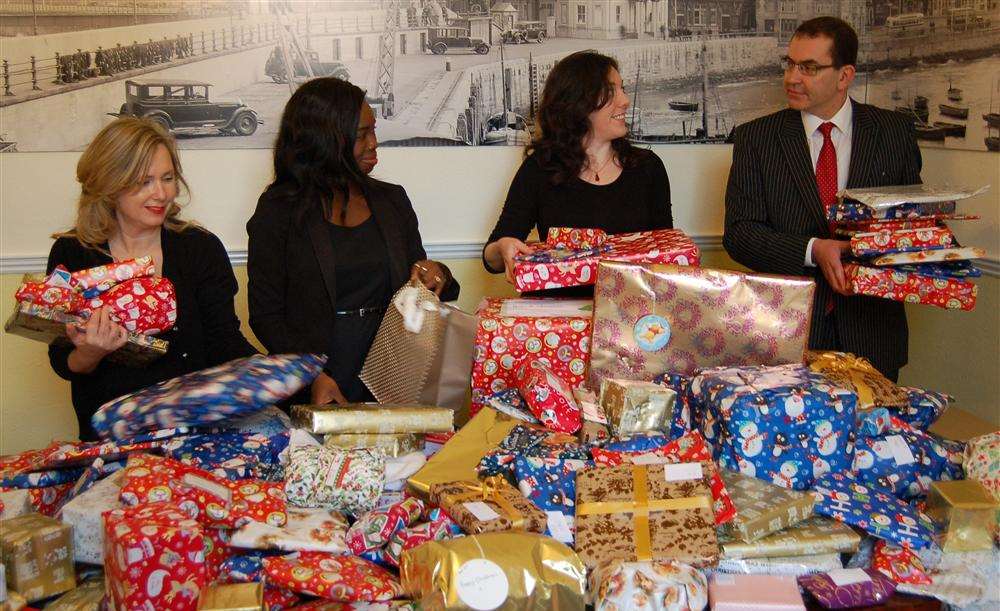 Staff at Boys and Maughan with some of the presents they have collected for Thanet's Oasis domestic abuse service, from left: conveyanver Liz Dack, company partner Mary-Joyce Insaidoo, Oasis fund-raising assistant Hazel Eddy and Boys and Maughan family law partner Jonathan da Costa.