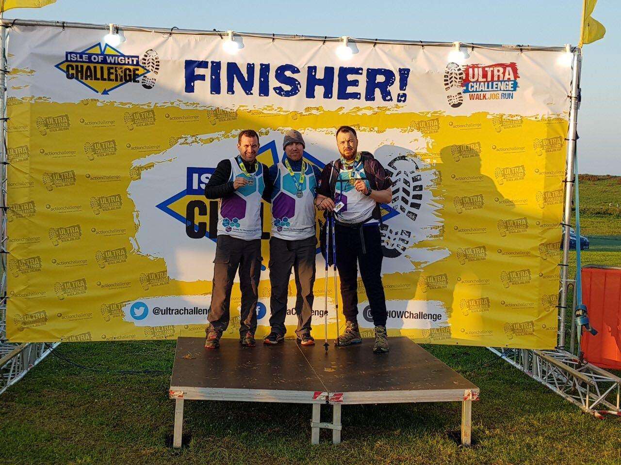 Kevin Mullins, left, with his friends after completing the Isle of Wight Challenge