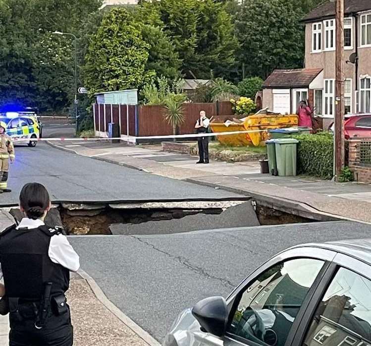 Police cordoned off the road after the sinkhole opened up. Picture: Liam Edwards/PA