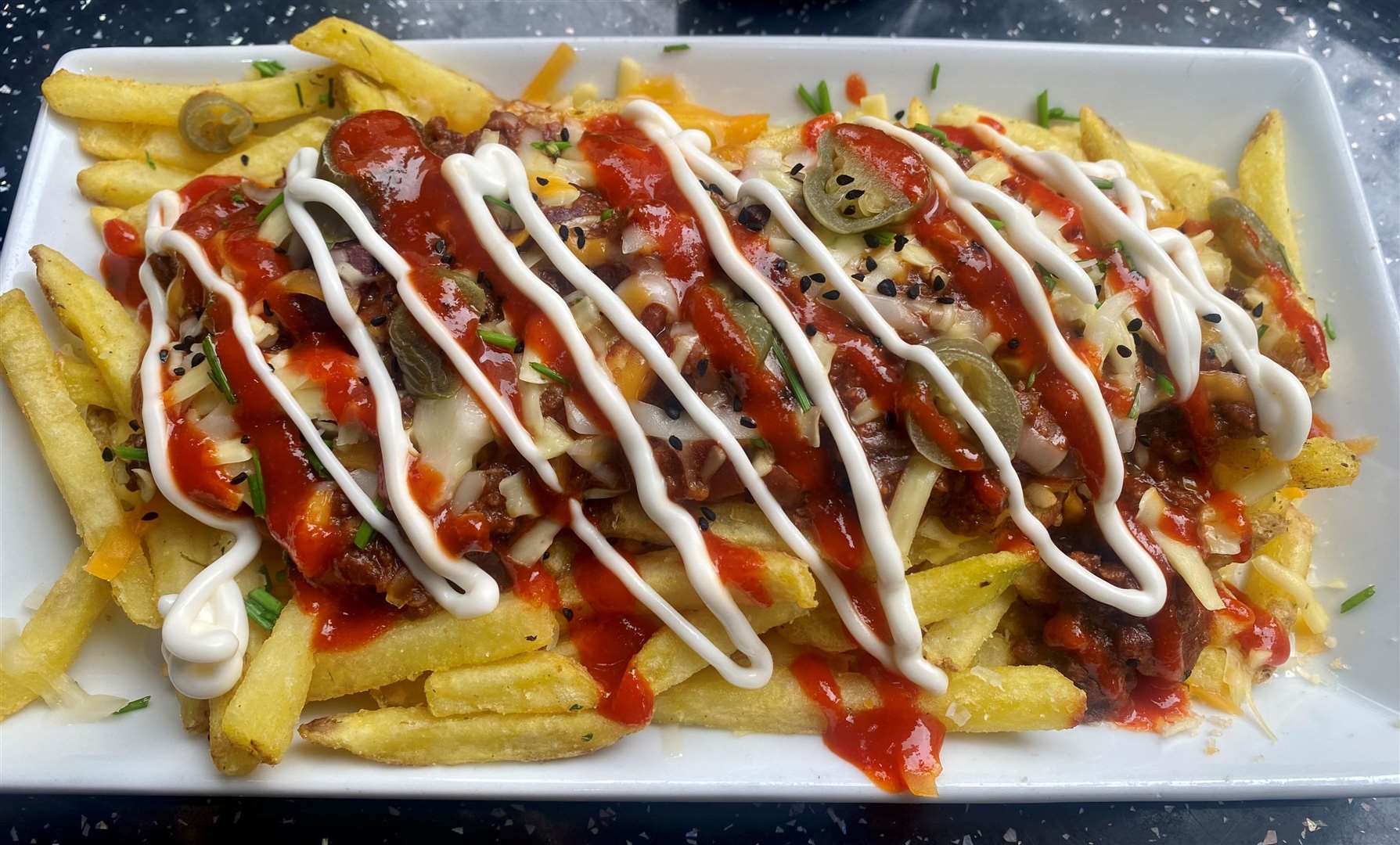 The spicy loaded fries came with hot sauce, chilli-non-carne and jalapeno peppers.
