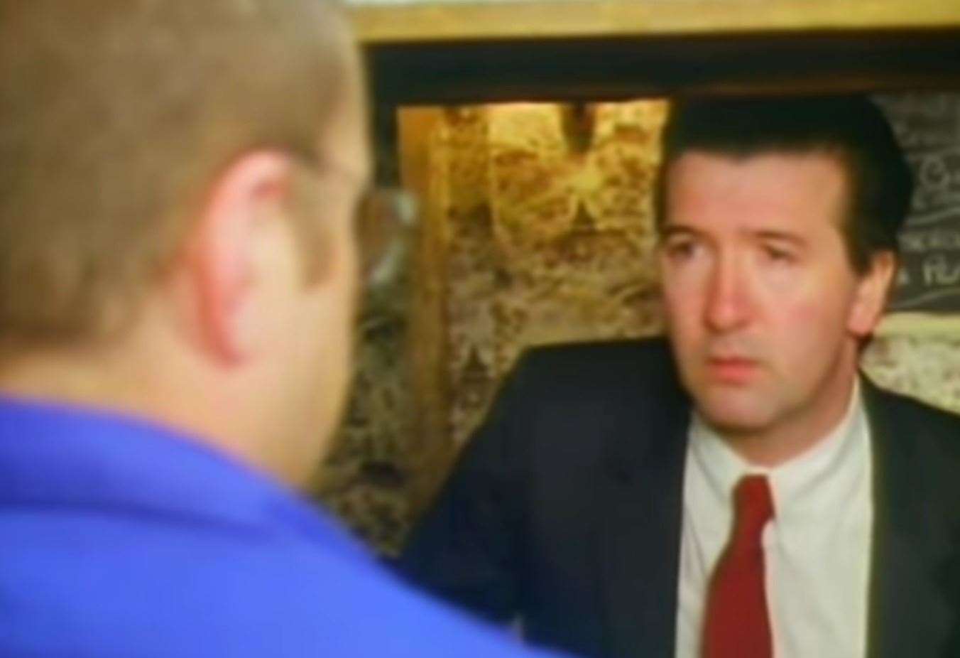 A still from the reconstruction. The actor in the red tie is portraying the man who inquired about Alan three weeks before his shooting. Picture: Crimewatch/redcard74 YouTube channel