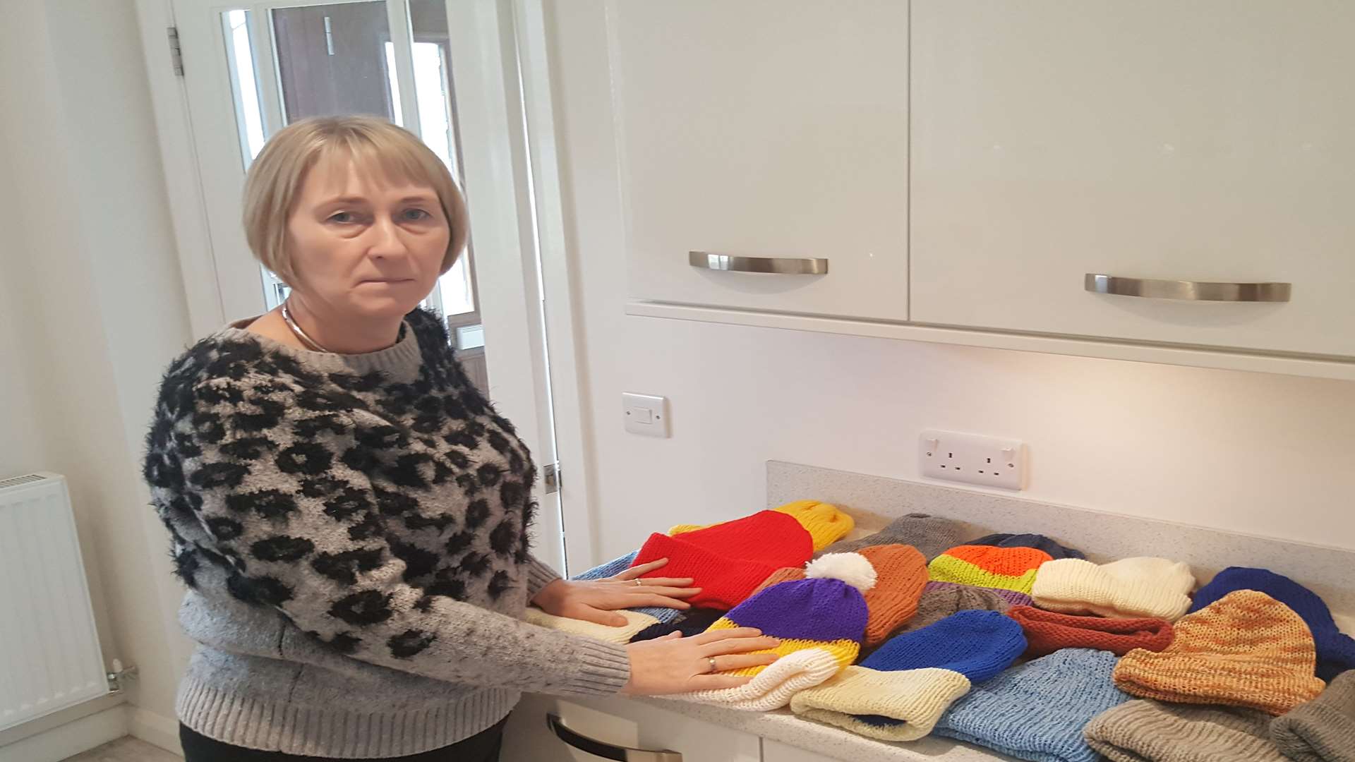 Amanda Evans and her knitted hats, which she donates to the homeless