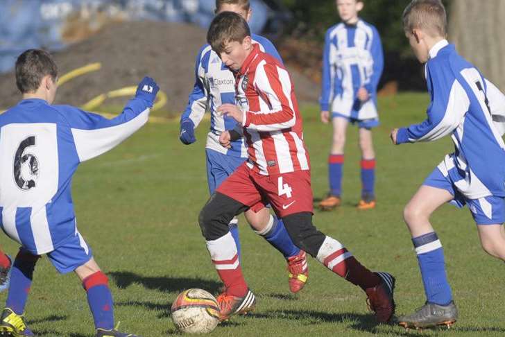 Oak Athletic, blue and white stripes, take on Strood United in the Under-11 League Division 1. Picture: Ruth Cuerden