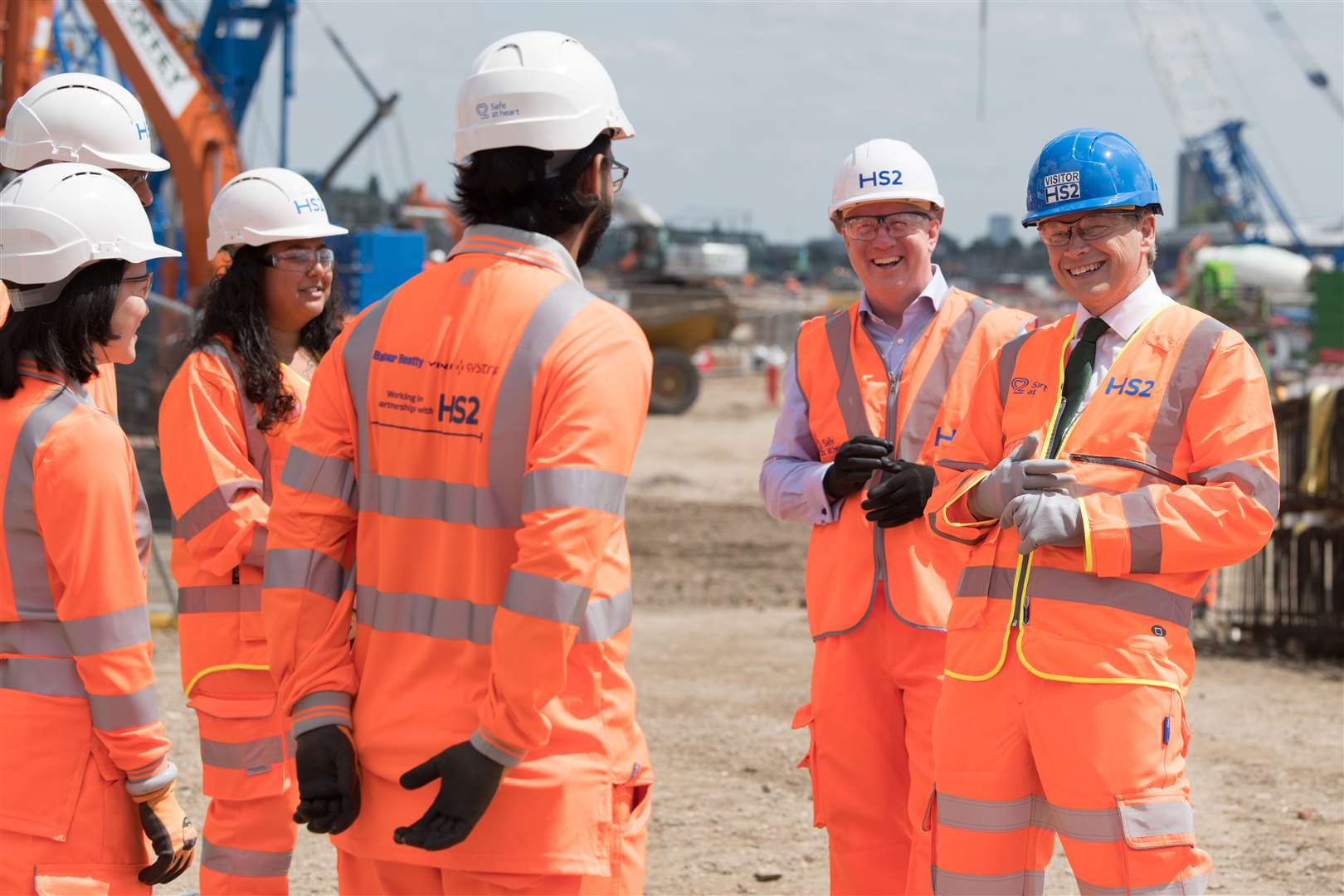 Transport Secretary Grant Shapps (far right) chats with apprentices during a visit to the HS2 ‘superhub’ at Oak Common station in west London in June 2021 (Stefan Rousseau/PA)