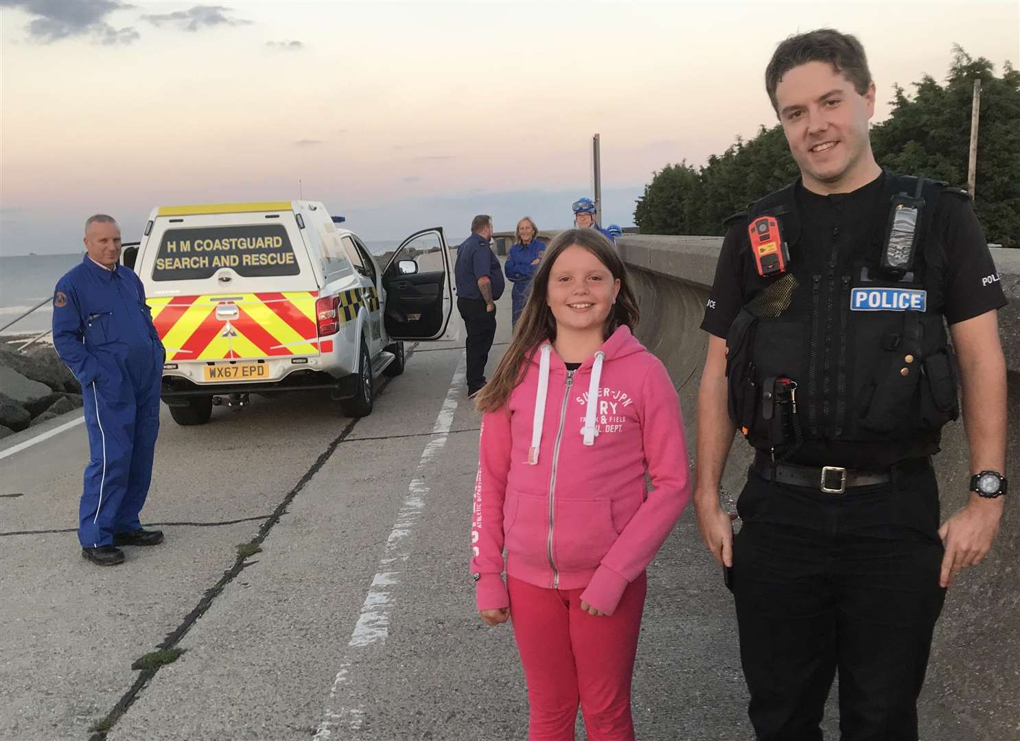 Isobel Osborne, nine, with a police officer after her find