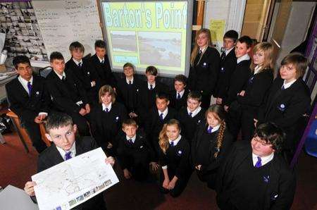 Some of the pupils involved, with a map of the coastal park