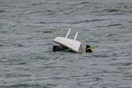 The dinghy capsized. Picture by Adrian Bennett