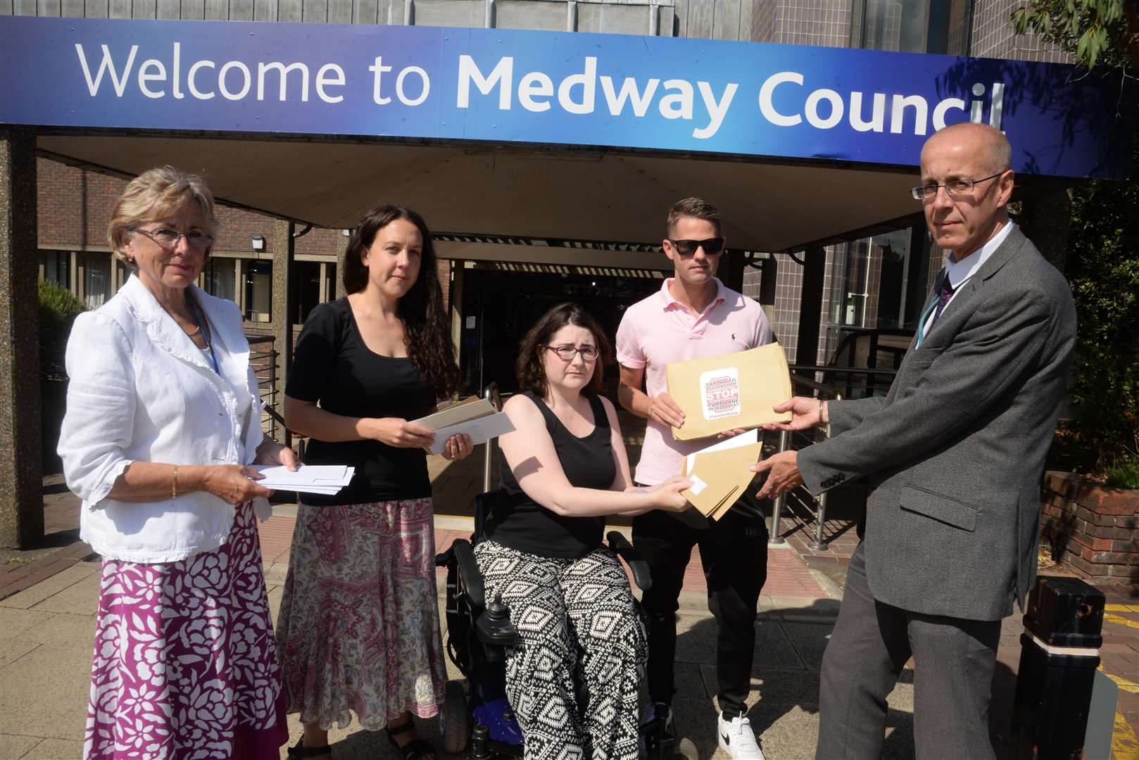 Cllr Kristine Carr, Catriona Jamison, Kate Belmonte and Cllr Martin Potter hand over petitions to Dave Harris, head of planning at Medway Council, over the proposed Pump Lane housing development at the council offices last August. Picture: Chris Davey