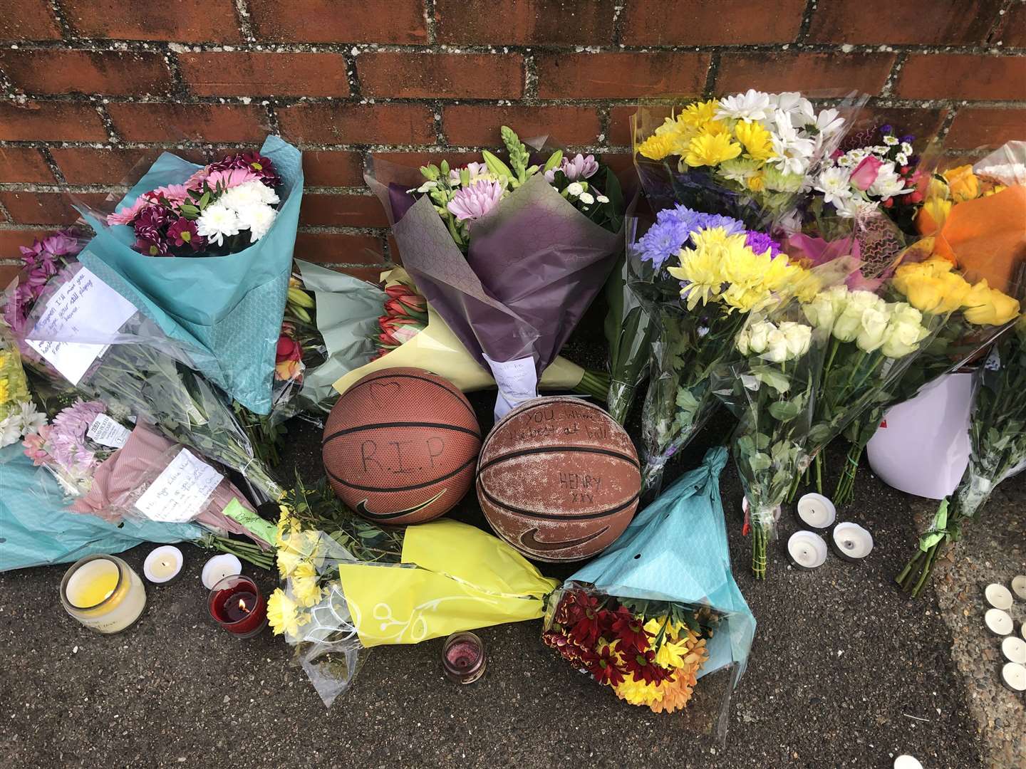 Floral, candle and basketball tributes were left at the scene. Picture from February