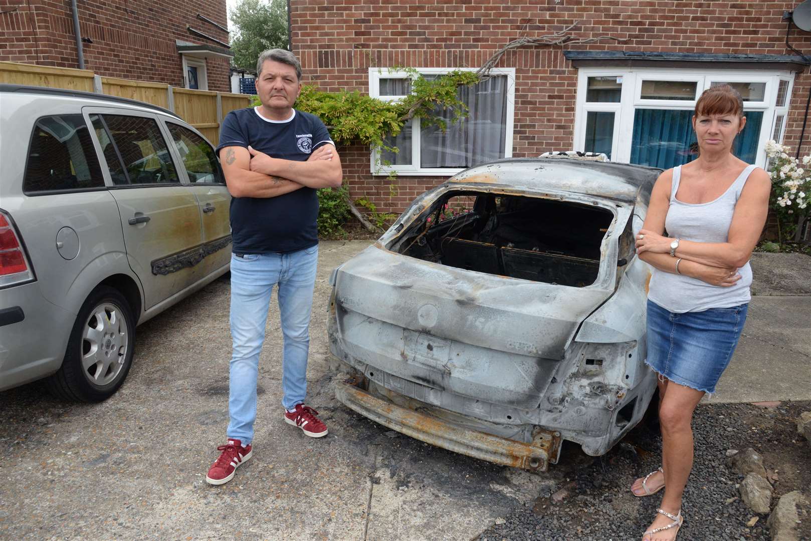 Taxi driver Tash Osman and his wife Jen whose cab was torched by an arsonist and damaged their other vehicle outside their home last week. Picture: Chris Davey. (13602419)