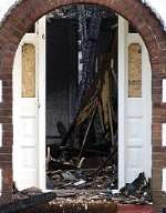 The bungalow's door and staircase severely damaged in the blaze