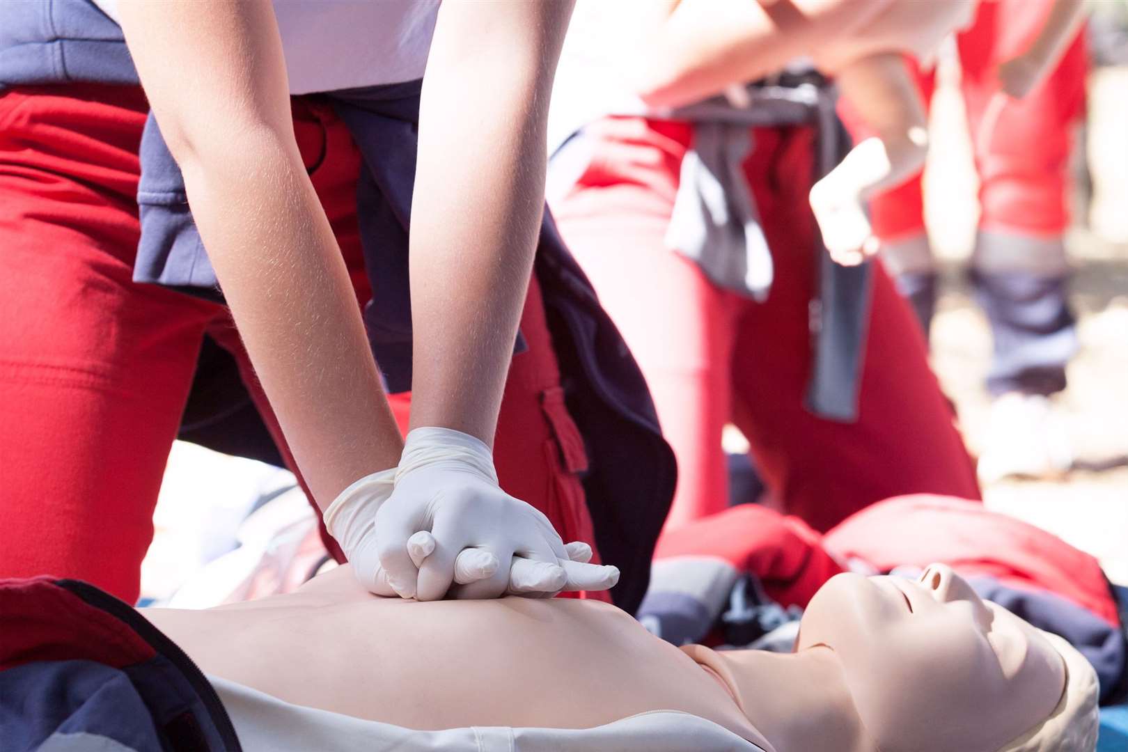 A paramedic demonstrates CPR on a dummy
