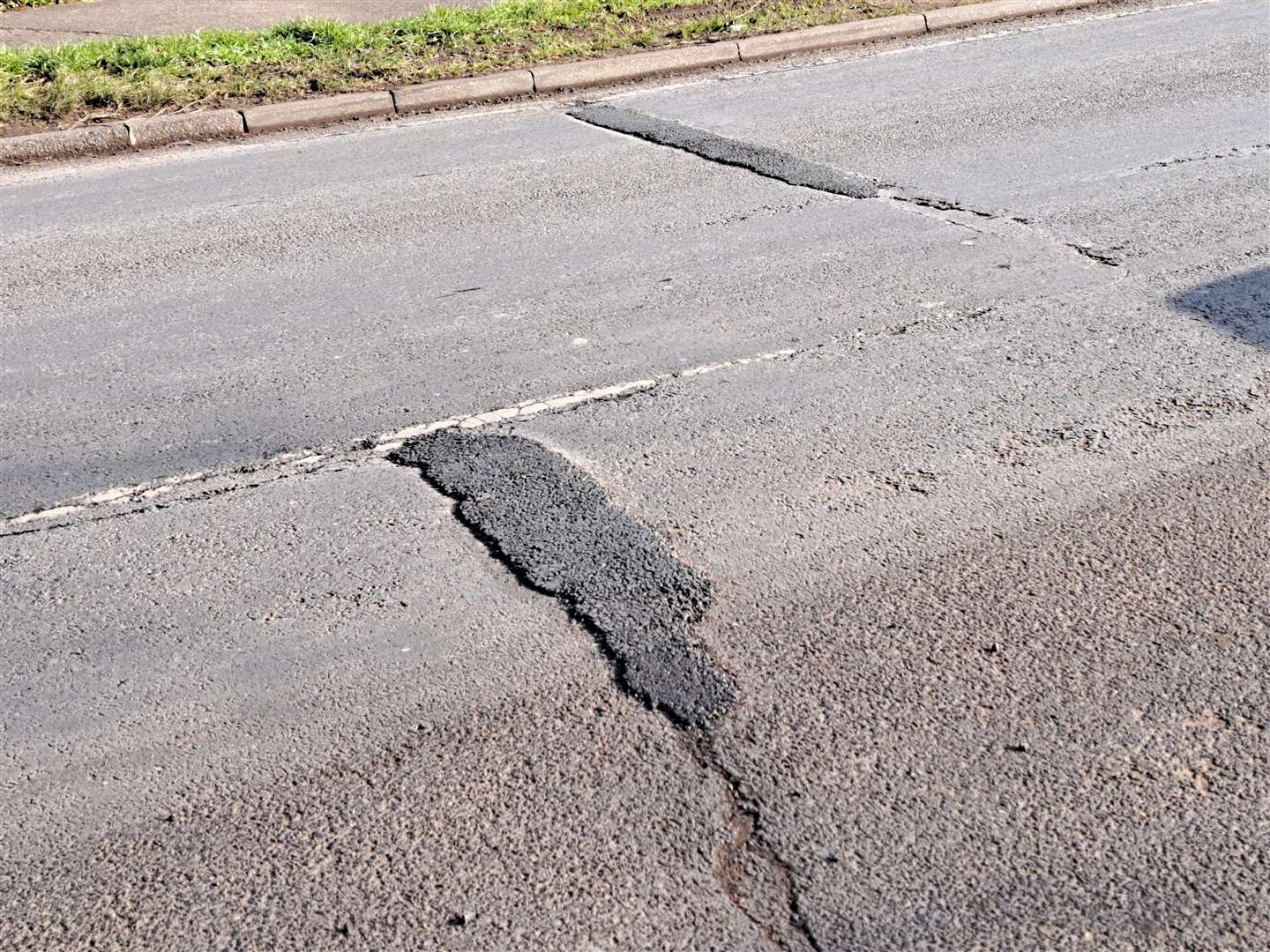 Recently repaired potholes in Kent Avenue