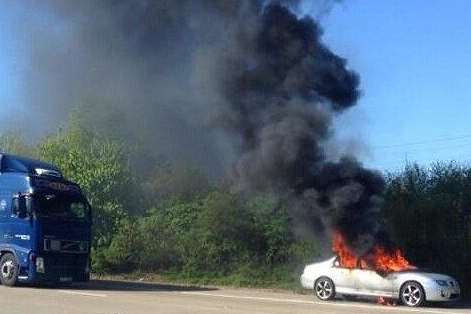 Smoke billows from a burning car on the M20. Picture: @gewlxx