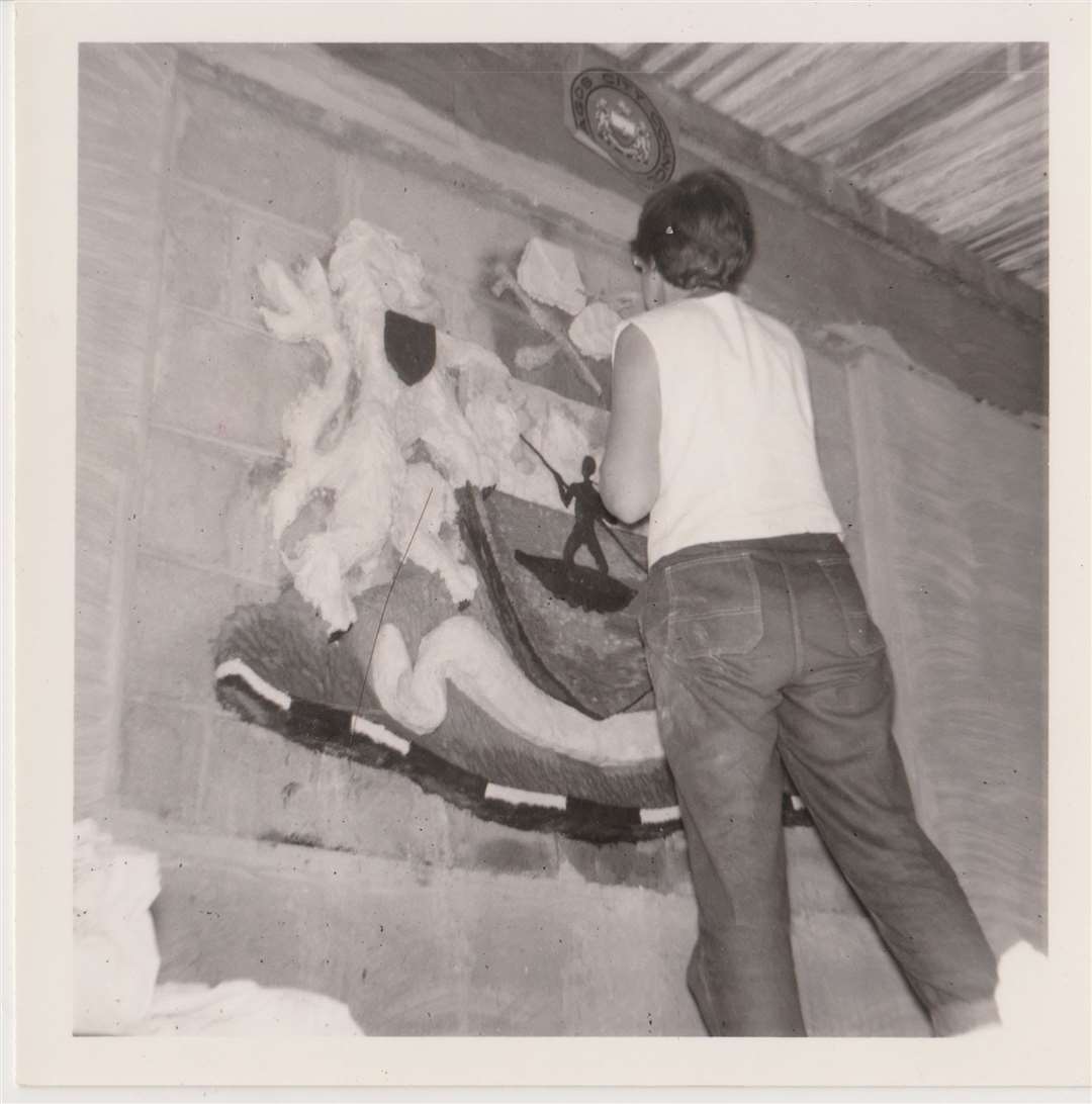 Audrey Jenkins painting the Coat of Arms at Lagos Library around 1961