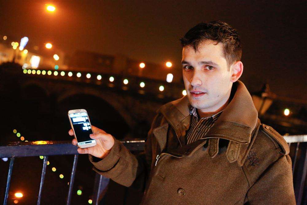 James Walker attempts to text to change the lights on the Broadway Bridge in Maidstone.