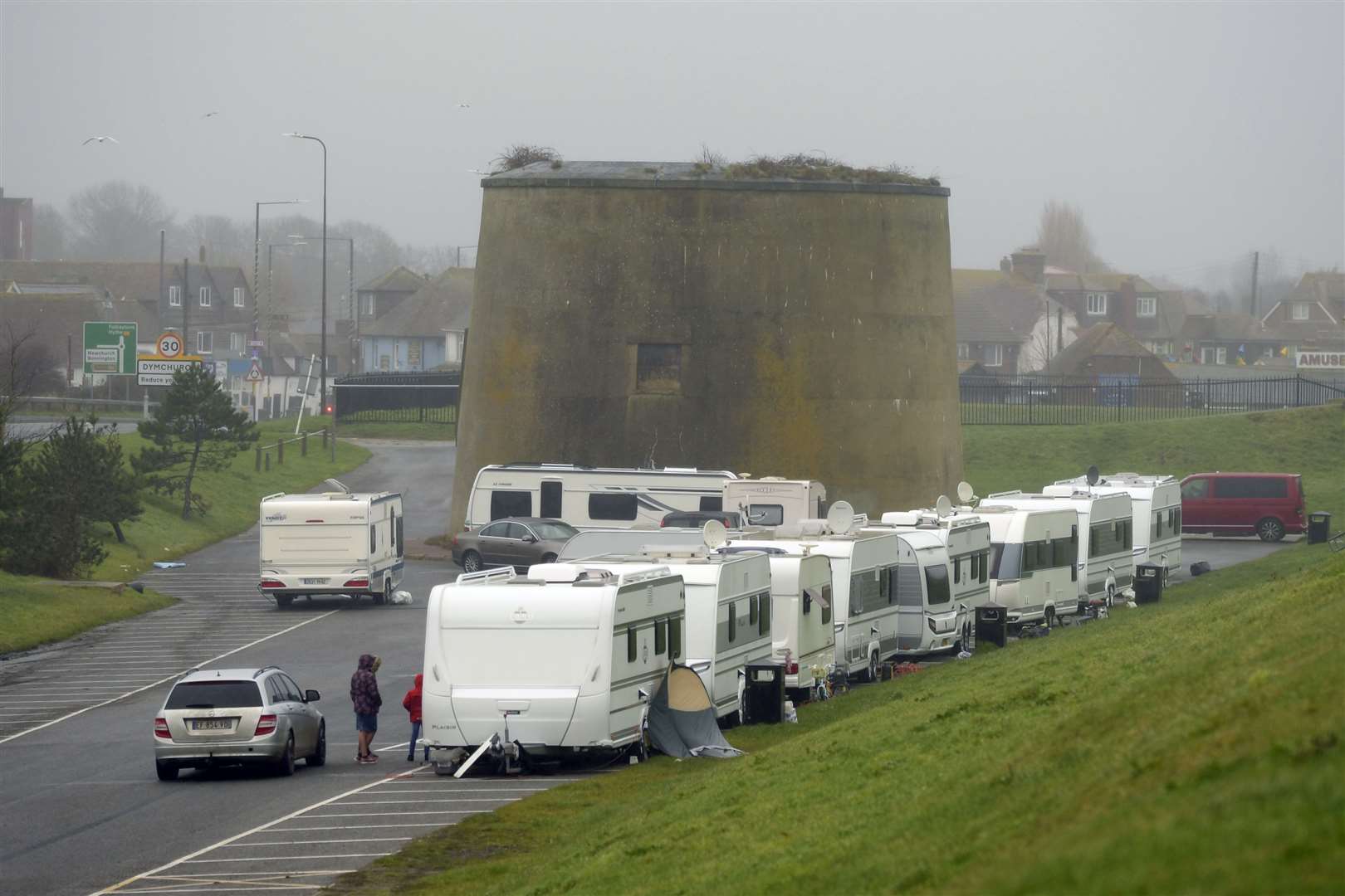 Caravans, all with foreign number plates, have parked in the lot, just off the A259. Picture: Barry Goodwin
