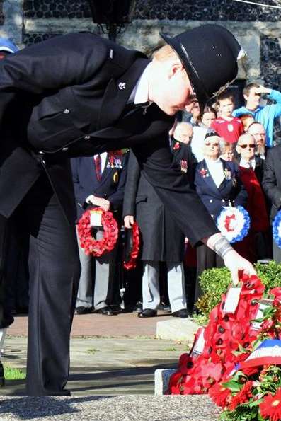 A policeman lays a wreath at a Remembrance Sunday service at Dover