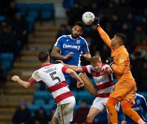Jordan Roberts jumps for the ball with keeper Seny Dieng Picture: Ady Kerry (29340136)