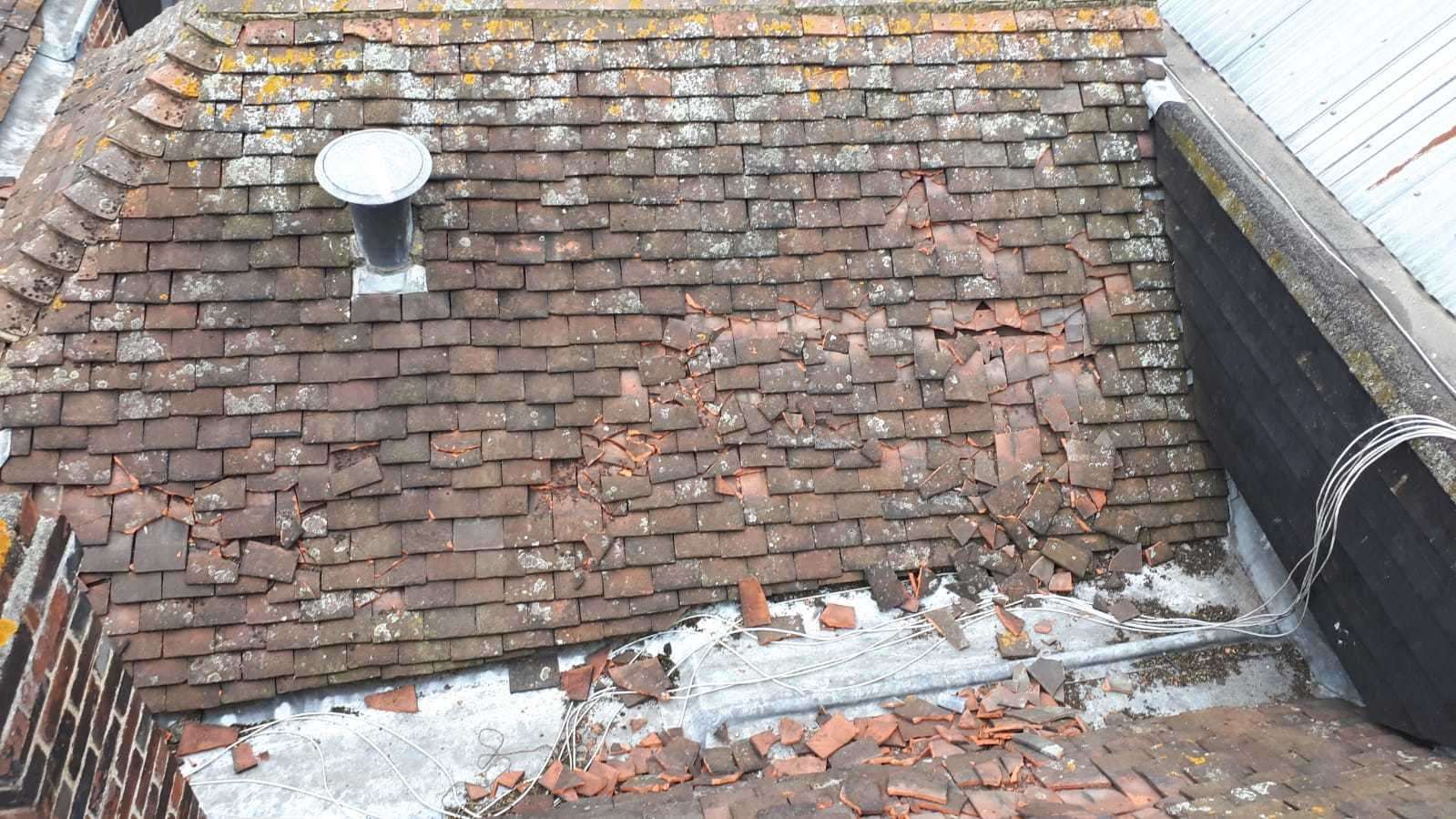 City roof tiles damaged by people running across them (53735293)