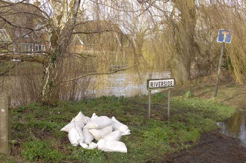 A supply of sandbags at the ready by the swollen Stour in Chartham. Picture: Chris Davey