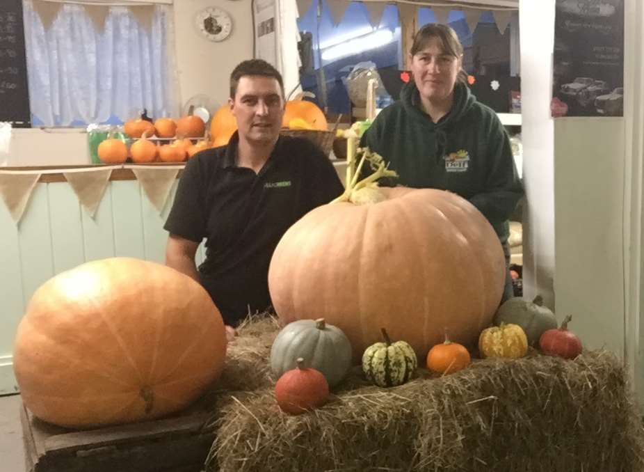 Alison and Simon Cock from Delf Farm Shop with some of the giant pumpkins they have grown